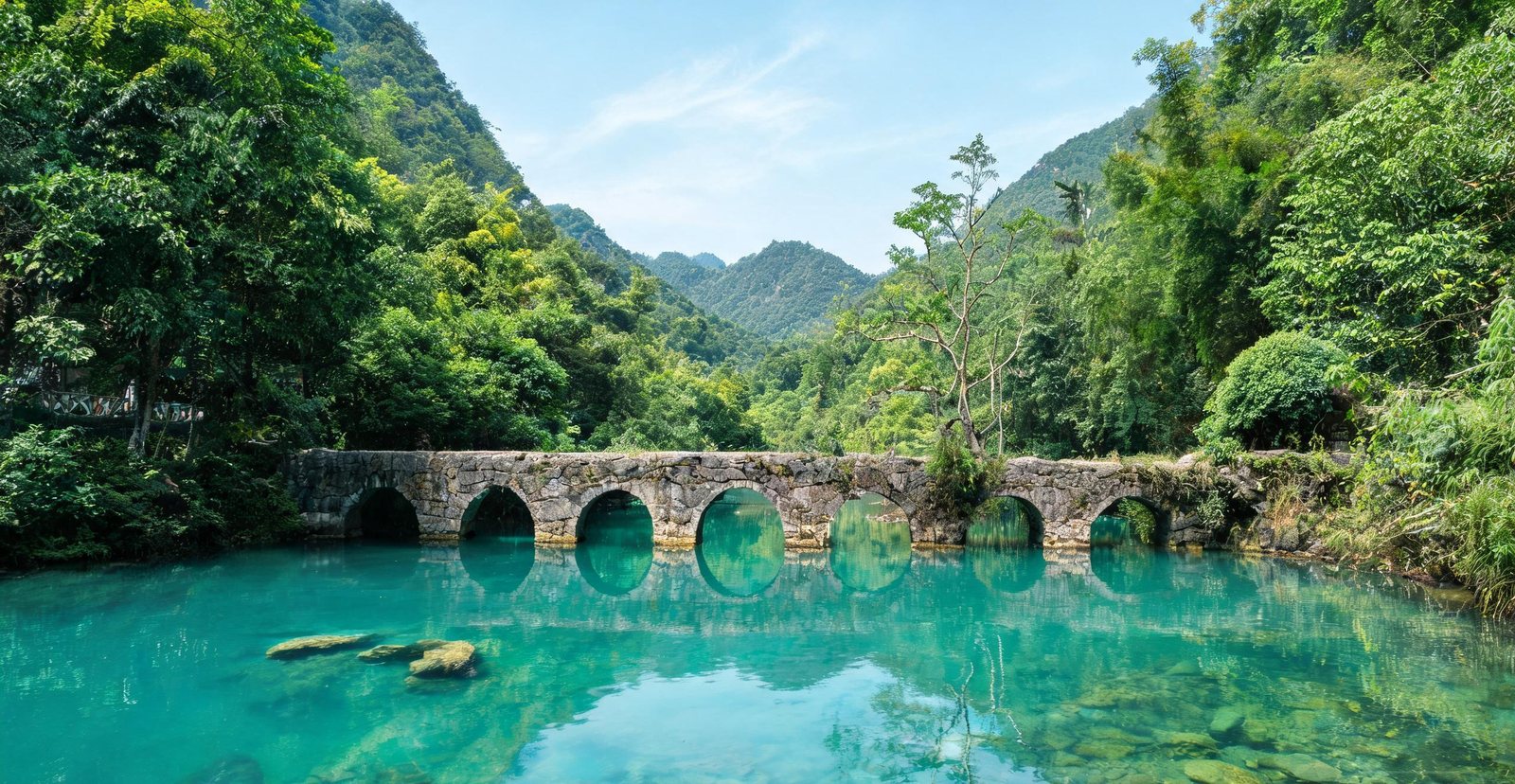 Emerald pools and stone bridge at Xiaoqikong, Guizhou